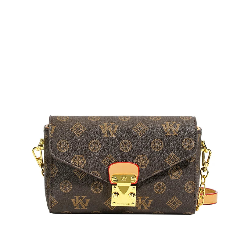 Brown monogram cowhide leather envelope crossbody bag with gold hardware, chain strap, and trunk-style clasp.