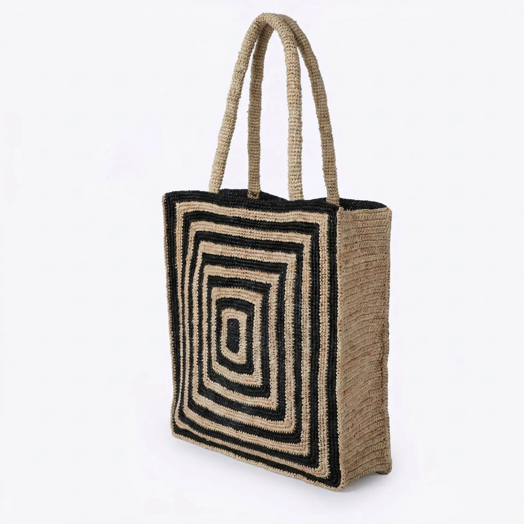 Lightweight woven straw tote bag with black and beige geometric square pattern, perfect for beach or daily carry.