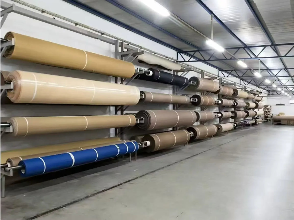 Row of brown heat-resistant tape rolls on an industrial spooling line