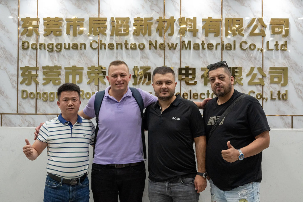 Heat-resistant tape company team posing indoors in front of reception wall