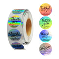 Round holographic thank-you sticker labels on a roll, assorted rainbow designs