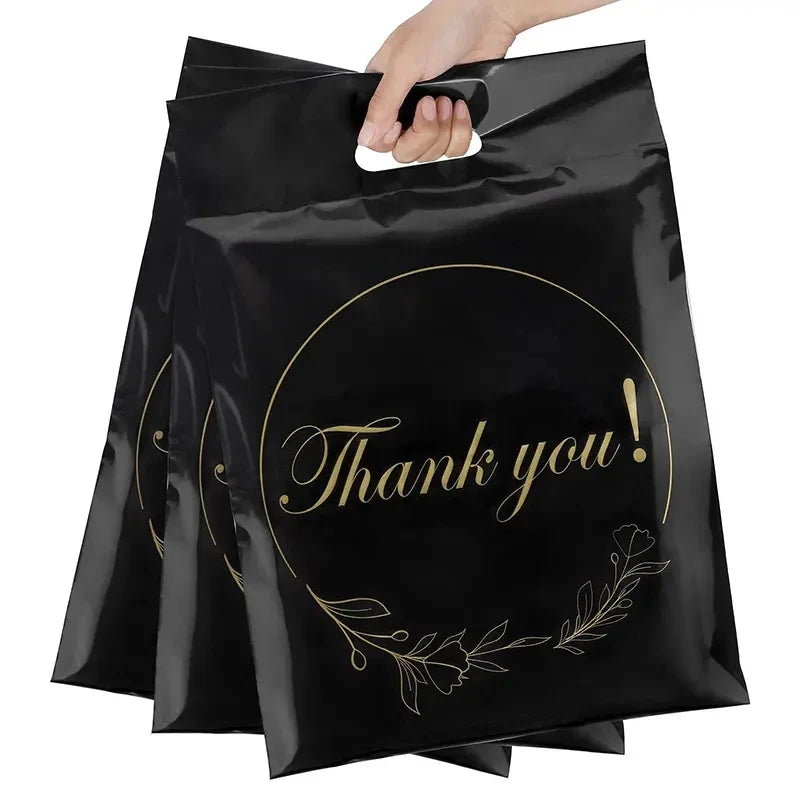 Black poly mailer envelope with gold “Thank you!” wreath-style graphic