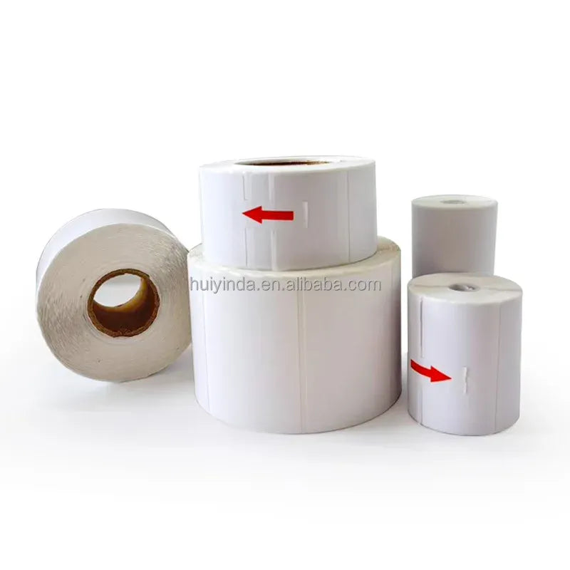 White thermal label rolls in various sizes with red arrows indicating direction
