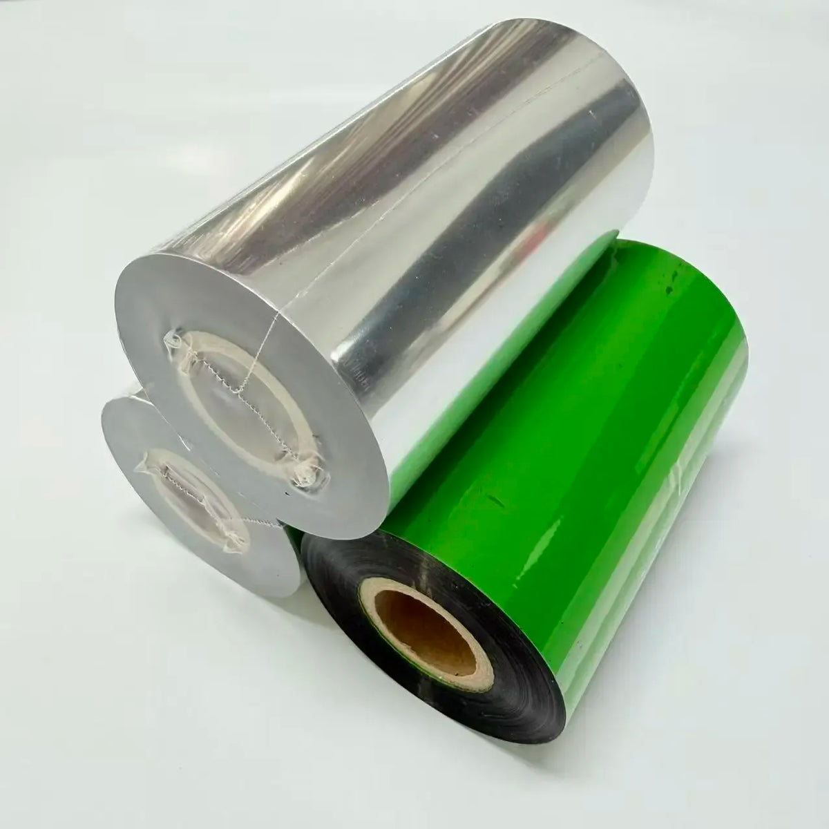 Wax thermal transfer ribbon roll, green and black tape on a silver core