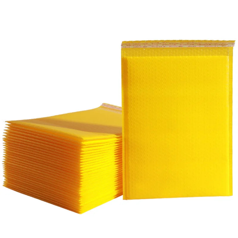 Stack of yellow bubble envelope bags with bubble-textured surface and sealed top