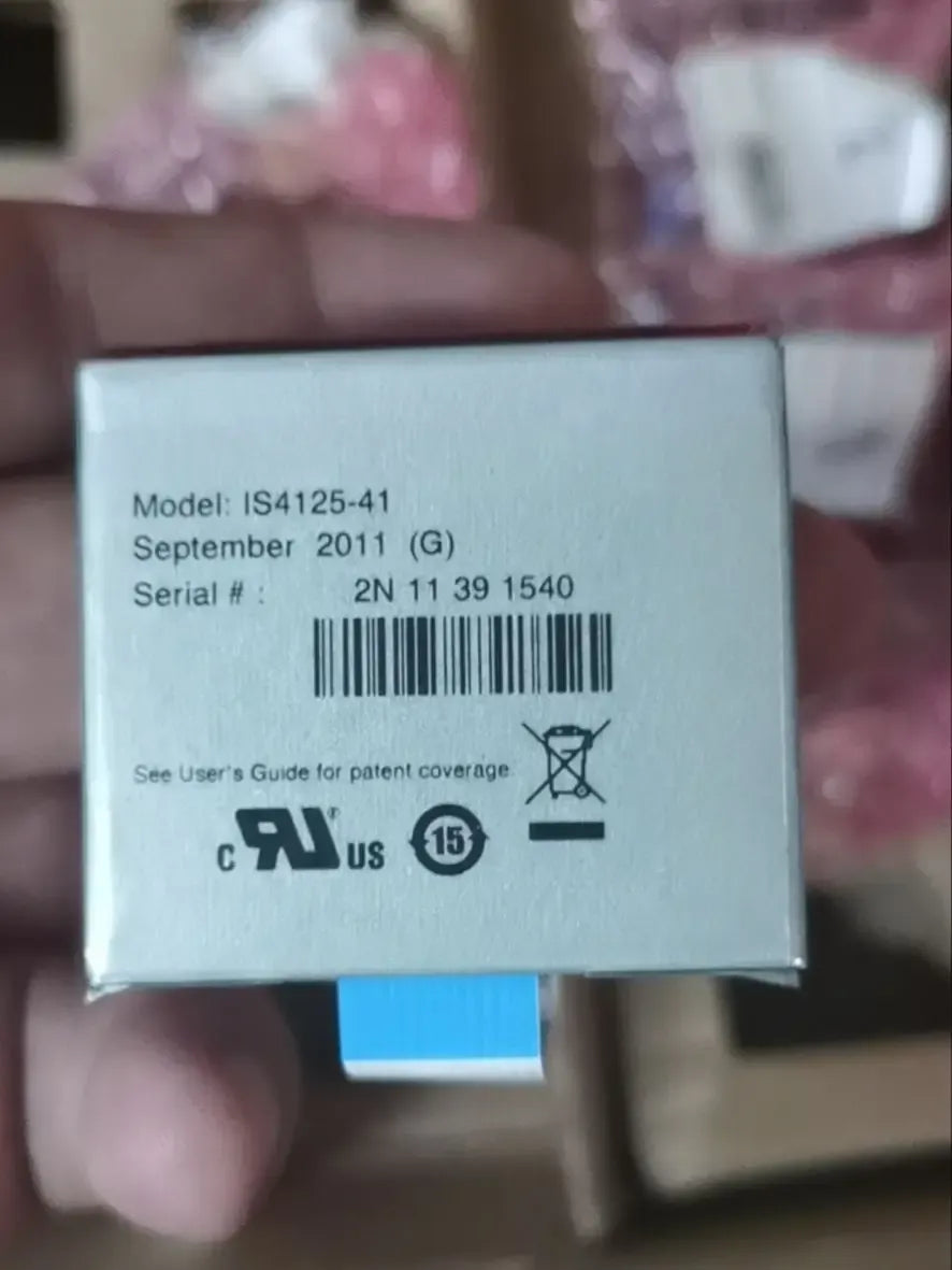 Barcode scanner interface box with model label IS4125-41 and serial, blue connector