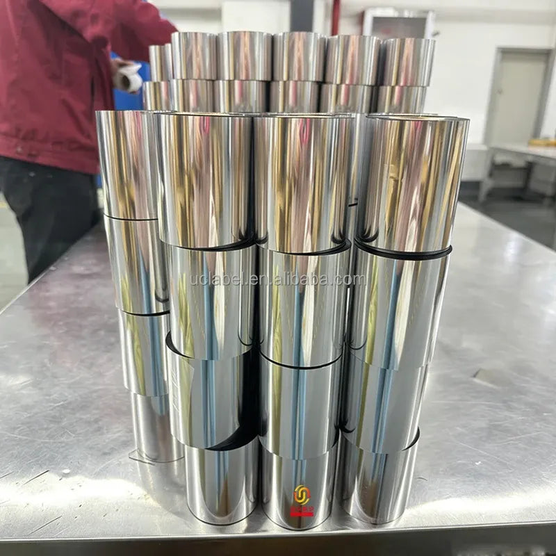 Stack of reflective thermal transfer ribbon rolls with gold cores and black bands