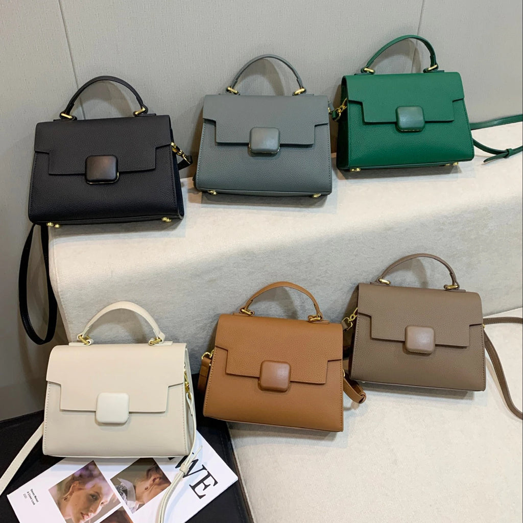 Designer leather shoulder handbags in various colors with a top handle and square magnetic flap closure.