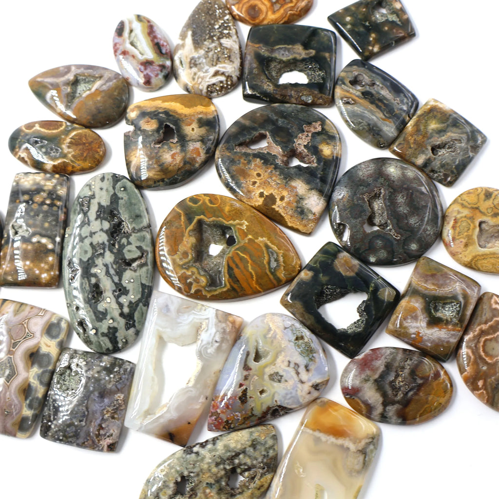 Wholesale lot of ocean jasper cabochon gemstones, assorted shapes with black, green, and gold bands