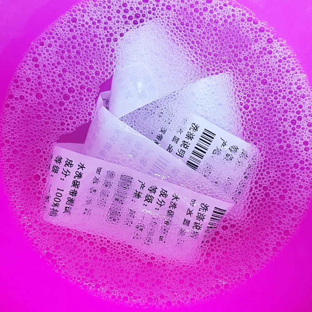 Wash-resin ink ribbon label strip and printed markings on white backing