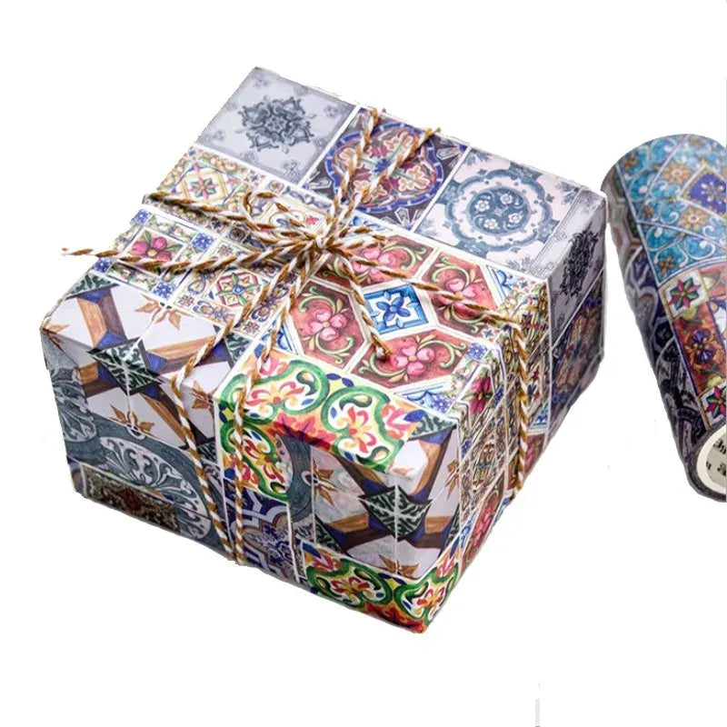 Decorative masking tape on a wrapped gift box with colorful collage and tile patterns