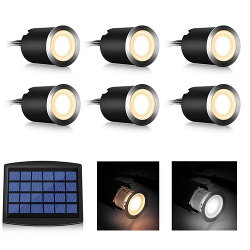 Six black recessed round LED deck lights with silver rims, warm lighting, connected to a solar panel.