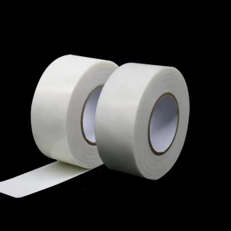White double-sided foam tape rolls with a long strip extended