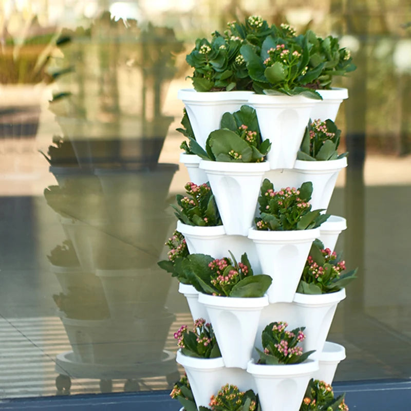 Stackable vertical flower pot planter tower, white plastic with green leaves and pink blooms