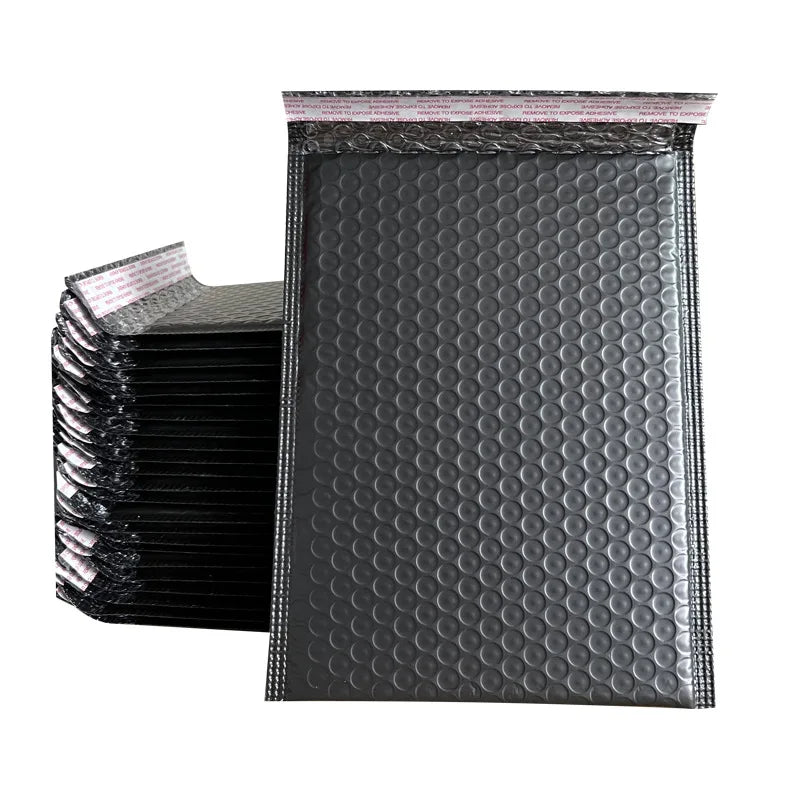 Waterproof padded bubble mailer bag, dark gray/black, multiple stacked envelopes