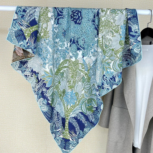 Luxury large square silk scarf in blue and green botanical peacock print with intricate foliage motif.