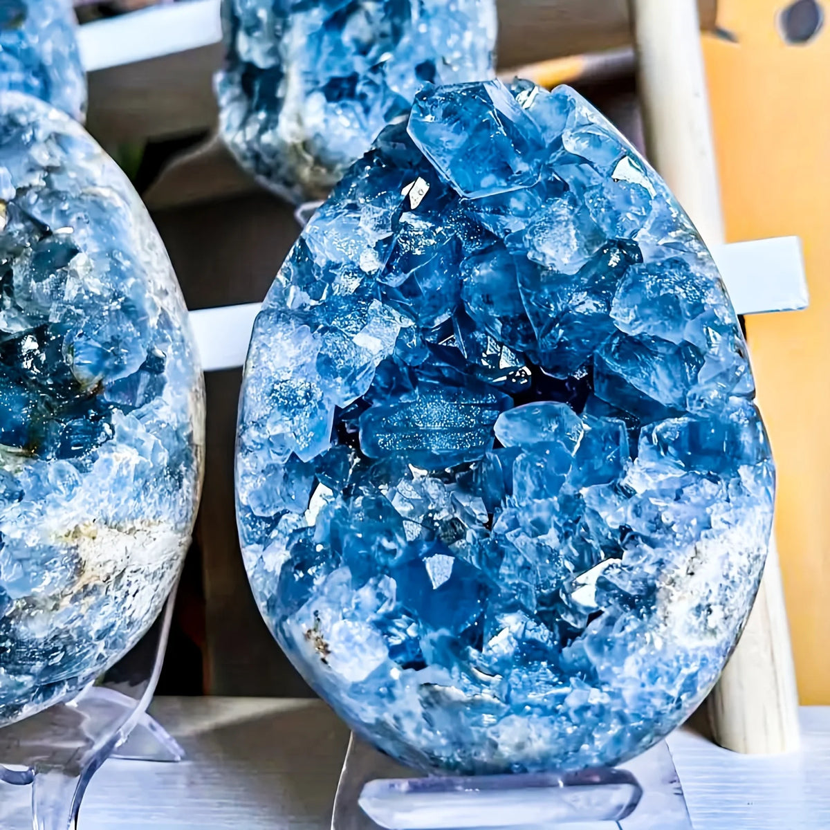 Blue celestite geode cluster in egg-shaped form with glittering crystal druse