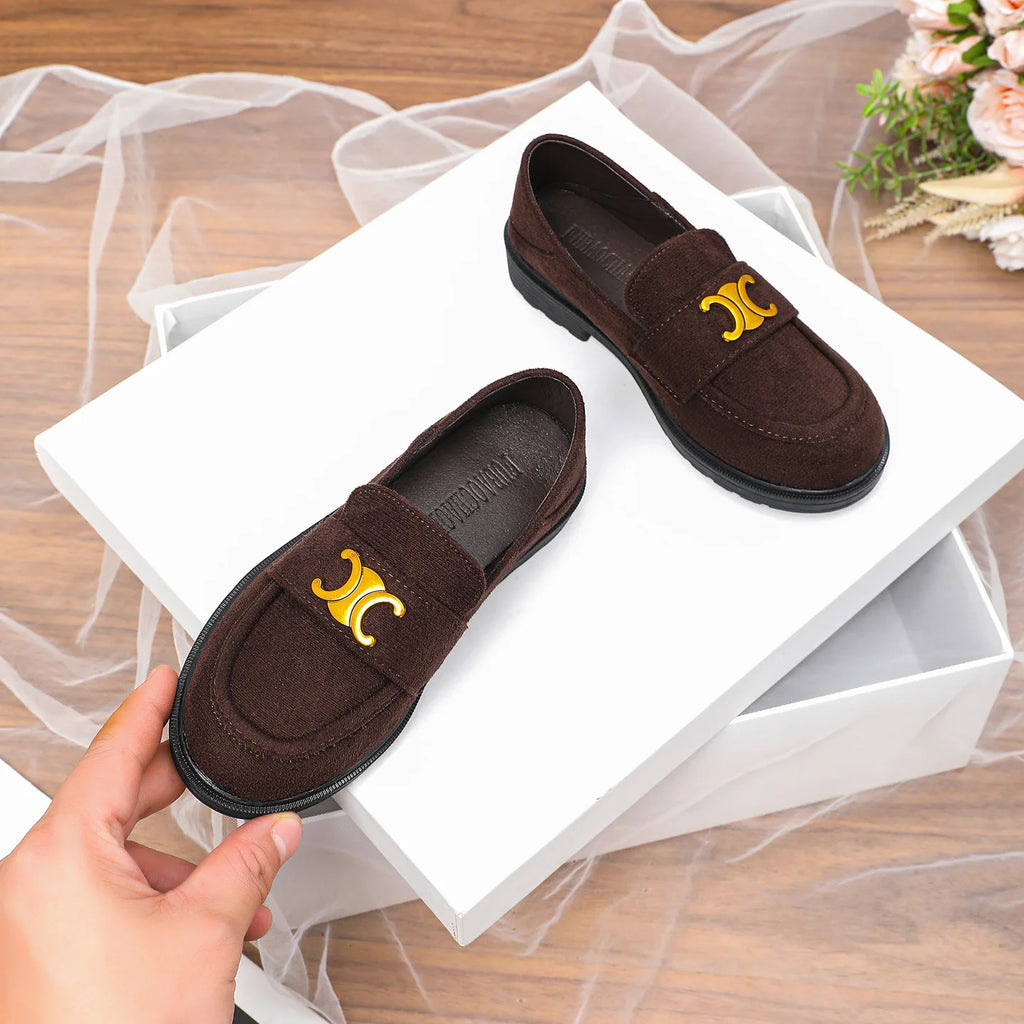 Luxury brown suede women's loafers with gold hardware emblem, round toe, and flat black lug sole.