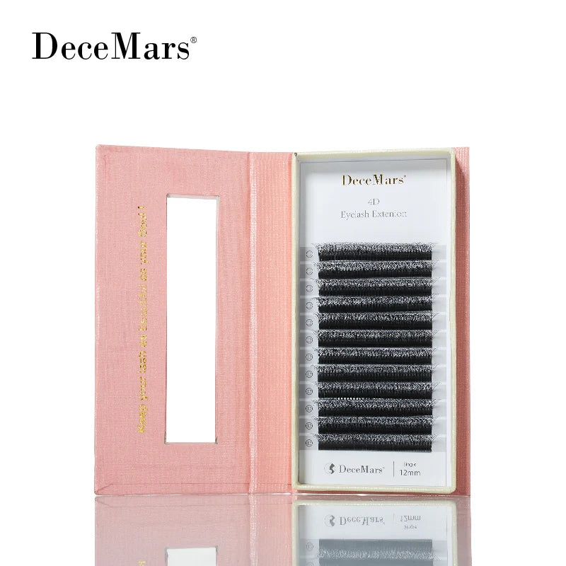 Tray of black 4D W-shaped eyelash extensions in a pink open box with gold lettering.