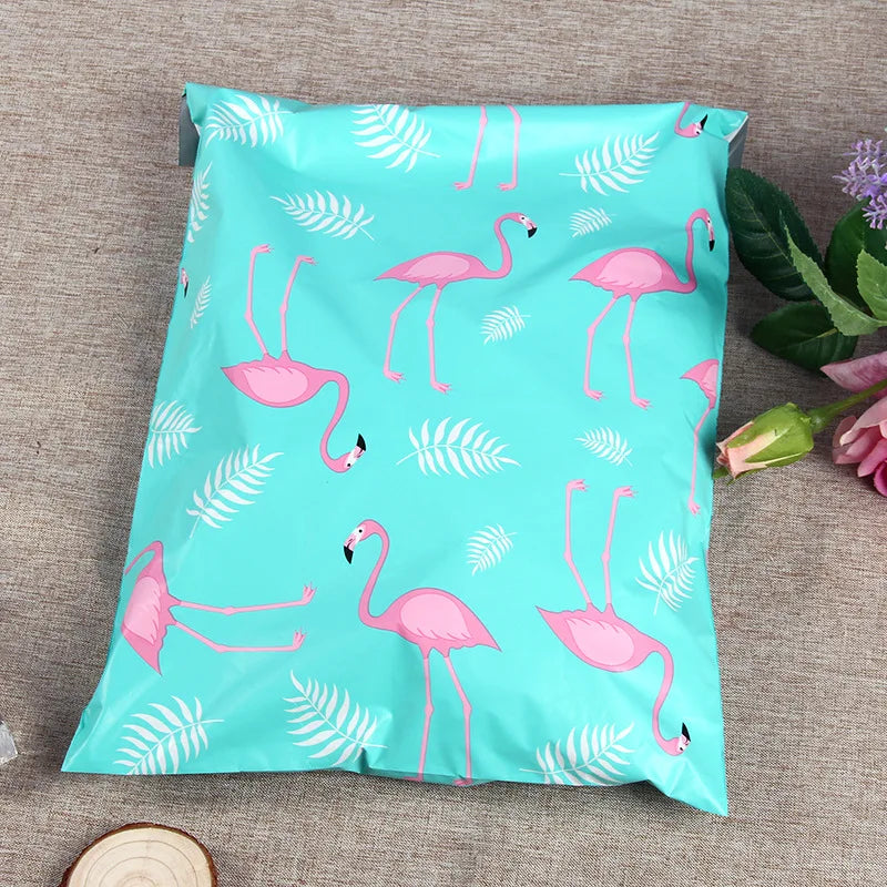 Turquoise plastic mailing bag with pink flamingo and leaf pattern