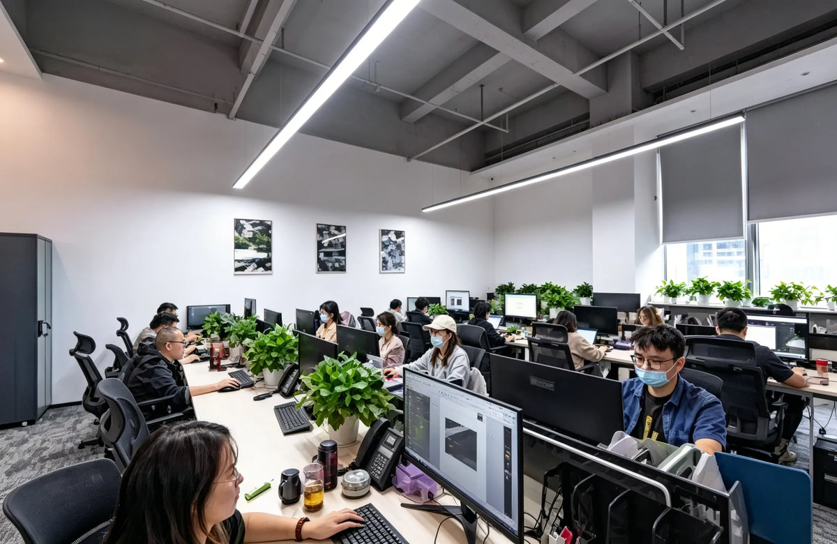 Open office workspace with people at desks and computers