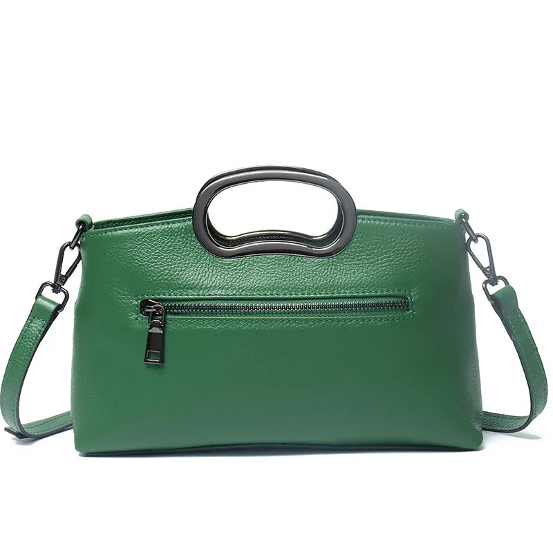 Green designer crossbody handbag in textured PU leather with metal top handles and a secure zippered exterior pocket.