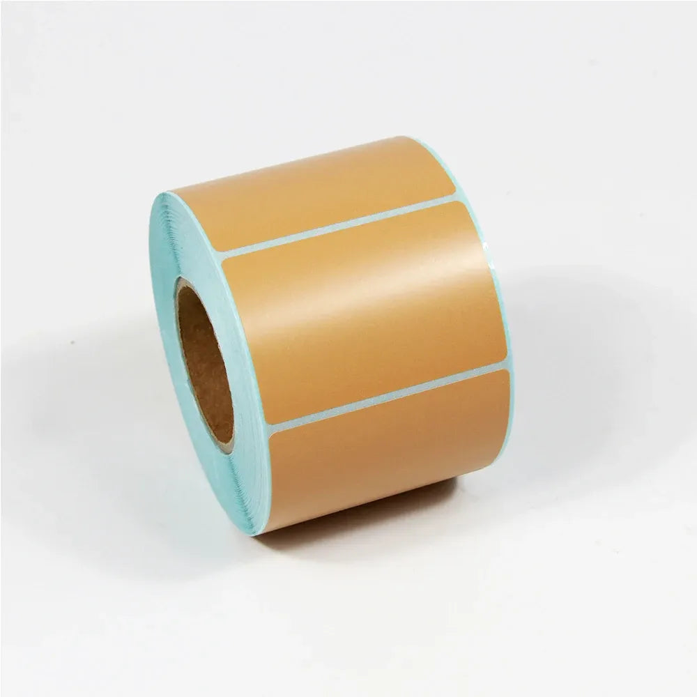 Tan thermal label paper roll with rectangular label outlines on the tape.