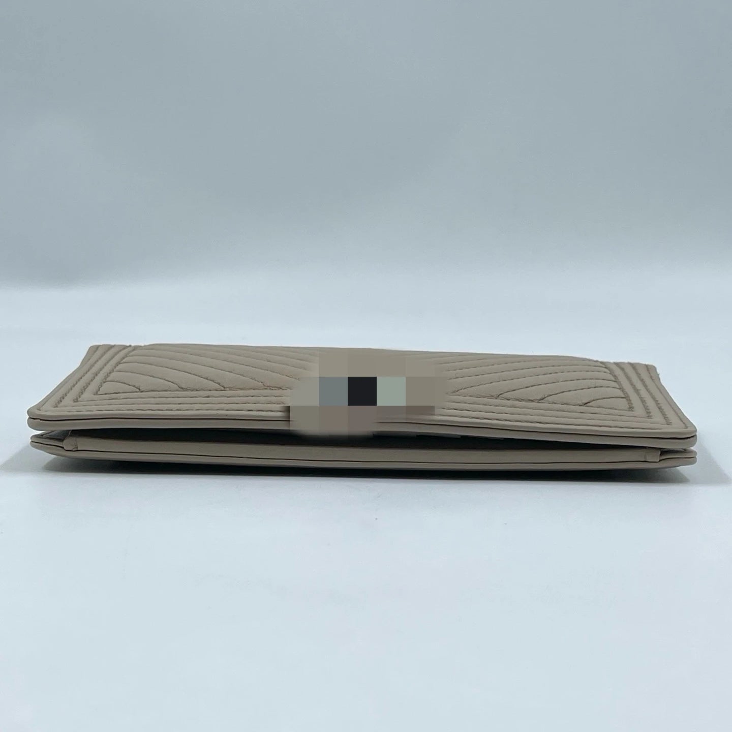 Elegant pre-owned designer tan leather wallet for women with chevron quilted stitching. Luxury fashion accessory.