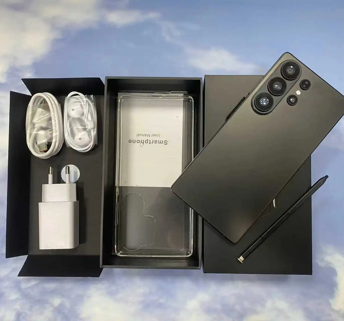 Black smartphone bundle with box contents: phone, charging cable, earbuds, and SIM tool.