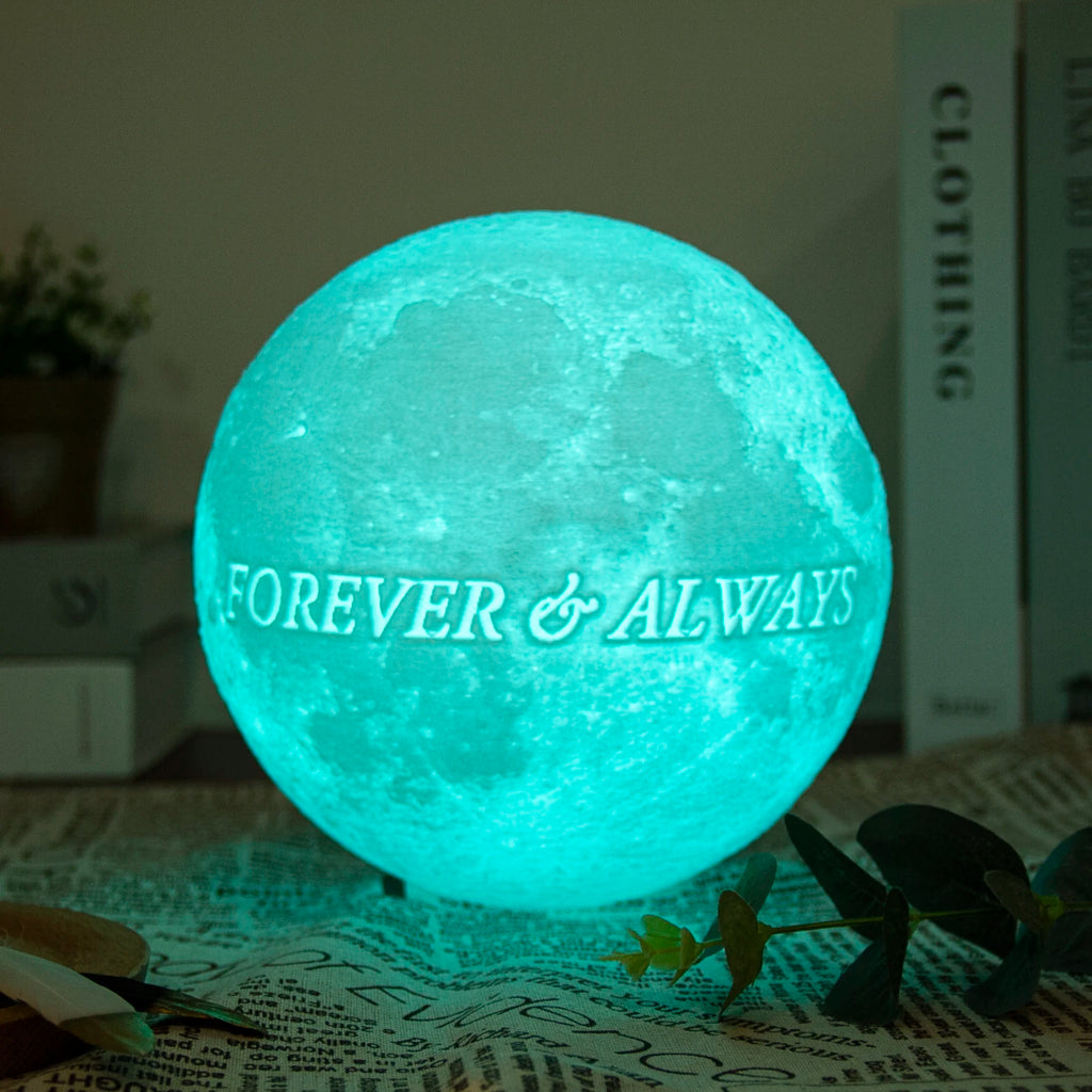 Glowing moon lamp with a textured surface, teal light, and the text "FOREVER & ALWAYS" for ambient room decor.