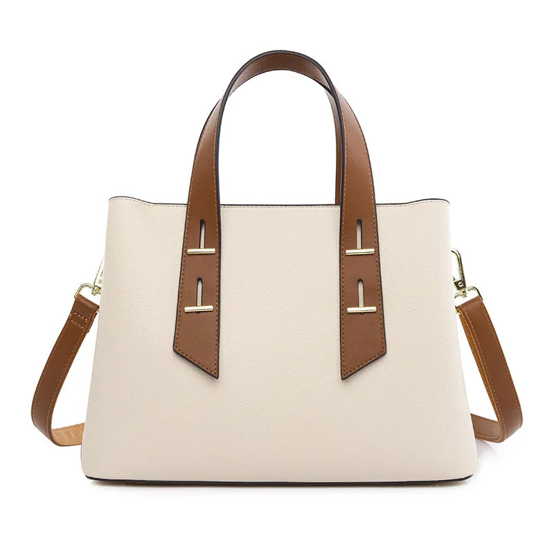 Off-white designer handbag with brown handles, gold hardware, and detachable shoulder strap in a luxury tote style.