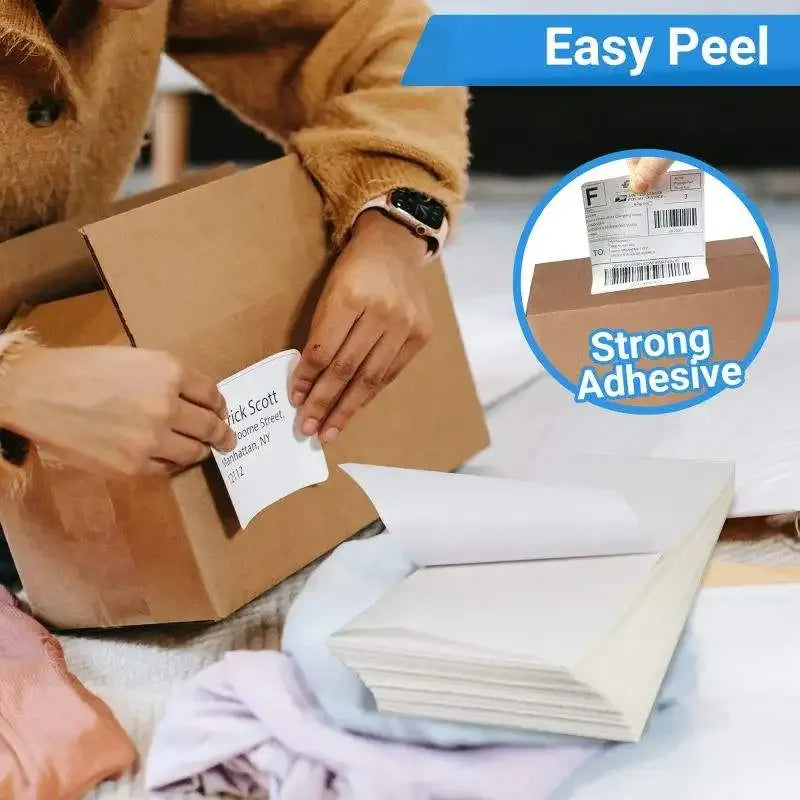 Self-adhesive thermal label stickers, easy peel, being applied to a shipping box