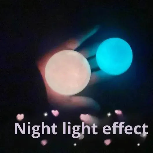 Hand holding a glowing pale ball with a bright blue glowing sphere behind it
