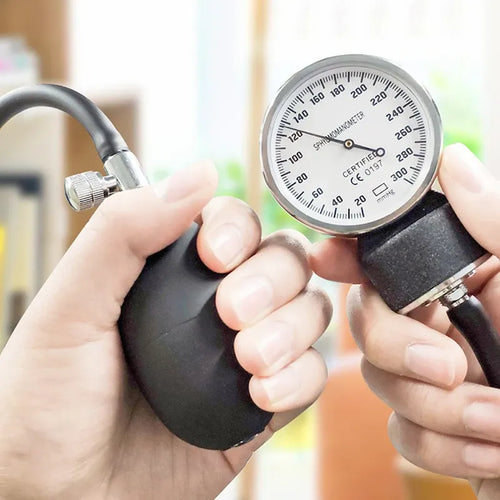 Manual arm blood pressure monitor/sphygmomanometer with black bulb and analog gauge for accurate health wellness tracking.