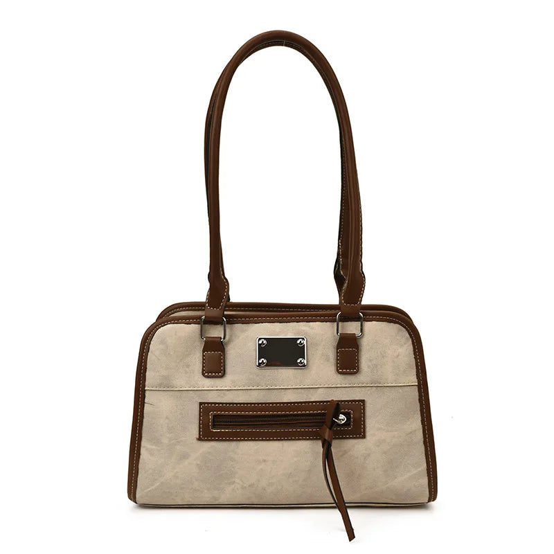 Beige and brown soft leather tote bag with top handles, front zip pocket, and metal plaque, stylish shoulder trunk.