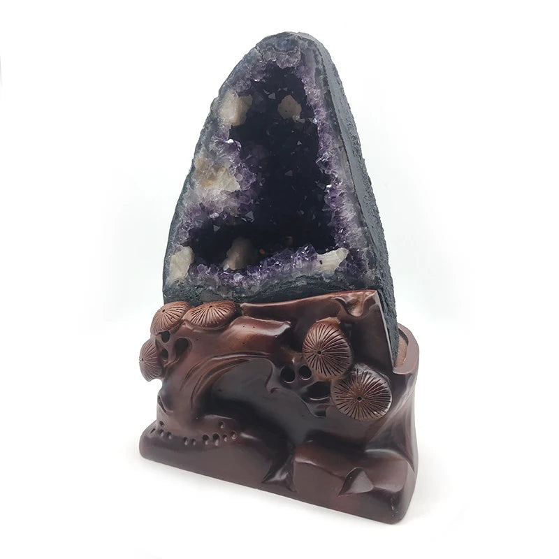 Purple amethyst geode ornament with carved brown base and detailed animal-like relief