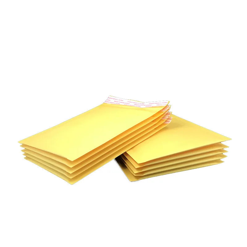 Stack of yellow padded mailers with orange inner layer, viewed from angled top