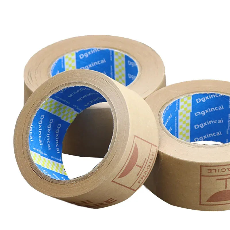 Close-up of brown kraft tape rolls with open cores and blue printed tape label