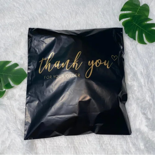 Black polyethylene mailer bag with gold "thank you" text and sealed fold-over top