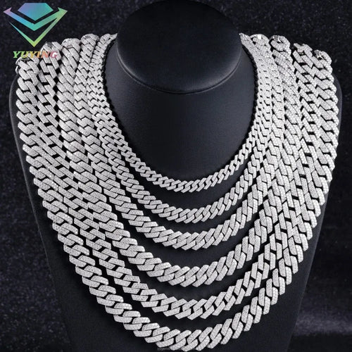 Layered Cuban link chain set with sparkling stones, white gold tone on necklace stand