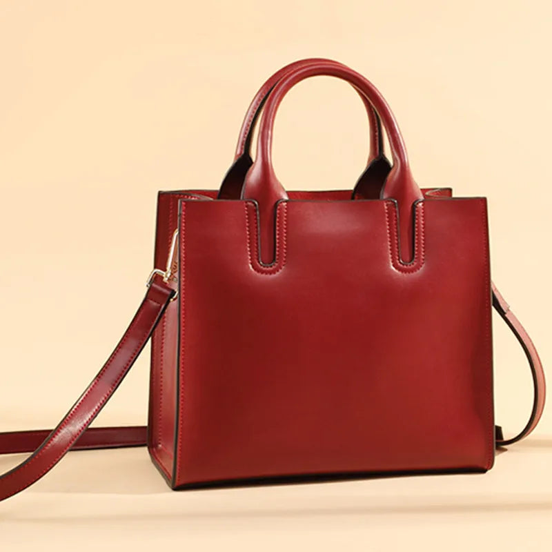 Red vintage genuine leather tote handbag with dual top handles, structured square silhouette, and detachable shoulder.