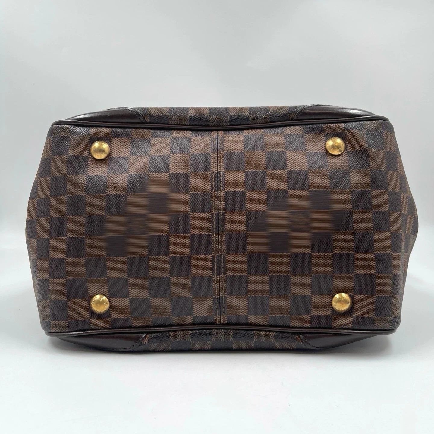 Brown checkered canvas designer handbag, vintage shoulder bag with gold-tone base studs. Unisex luxury style.