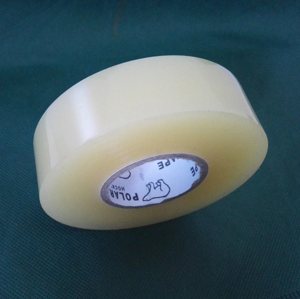 Pale yellow tape roll close-up with visible inner core and side edge