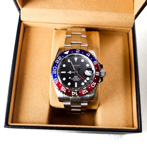 40mm stainless steel automatic mechanical watch with a red and blue GMT bezel in a luxury presentation box.