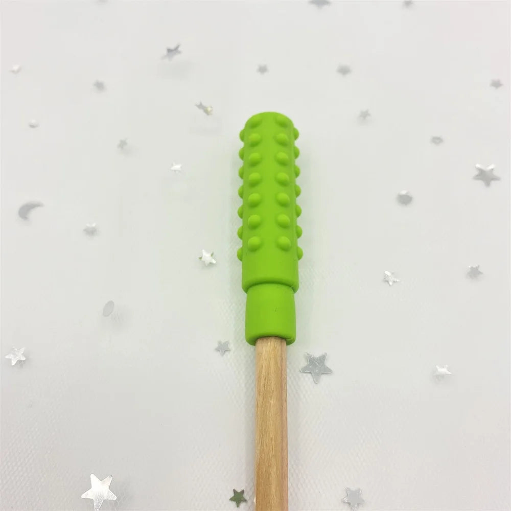 Green silicone and natural wood baby teething toy for pain relief.
