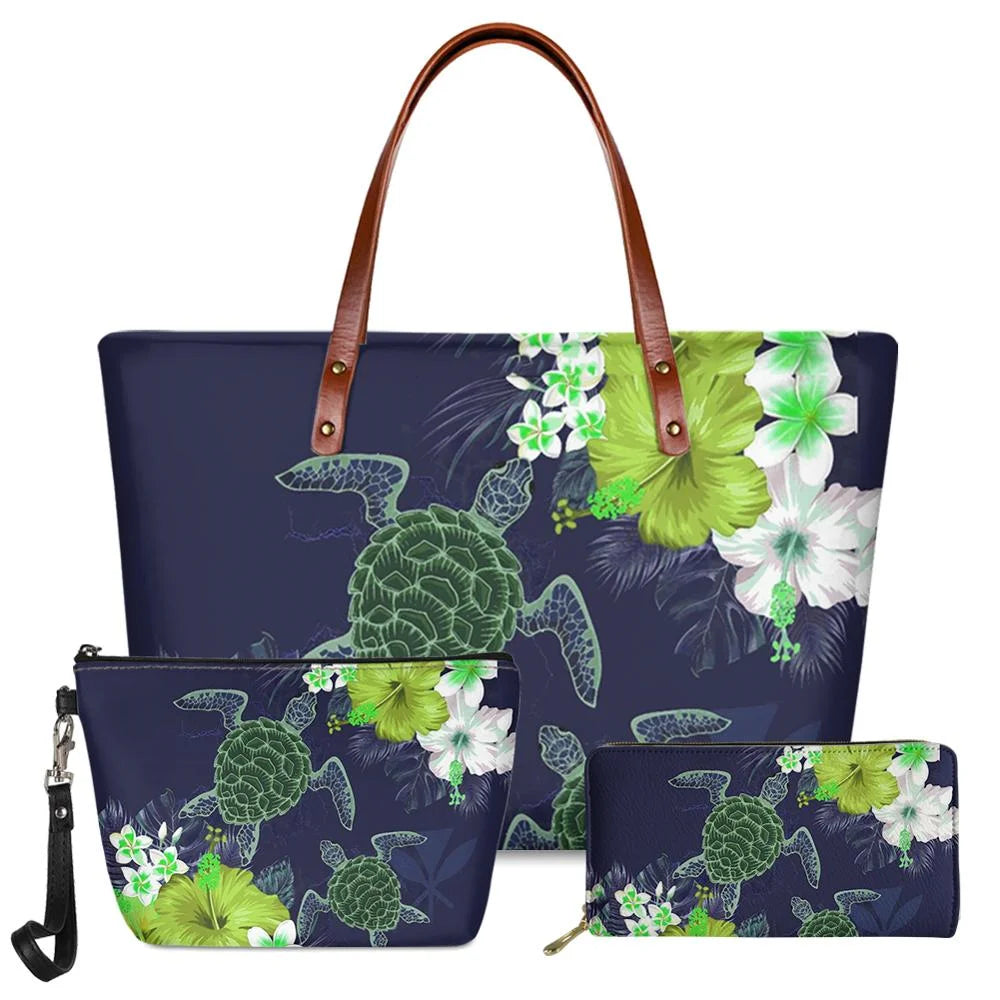 3-piece navy handbag set with Polynesian sea turtle and hibiscus floral print, featuring brown leather shoulder straps.
