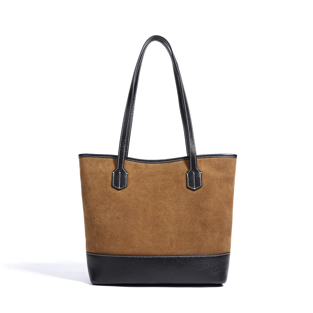 Brown suede underarm tote bag with black leather trim, contrast stitching, and minimalist vintage style.