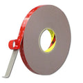 Double-sided acrylic tape roll with red printed edge strip and loose end adhesive