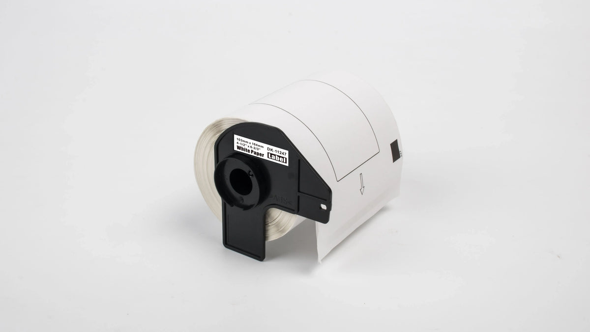 Blank direct thermal label roll in black-and-white cartridge, label backing visible