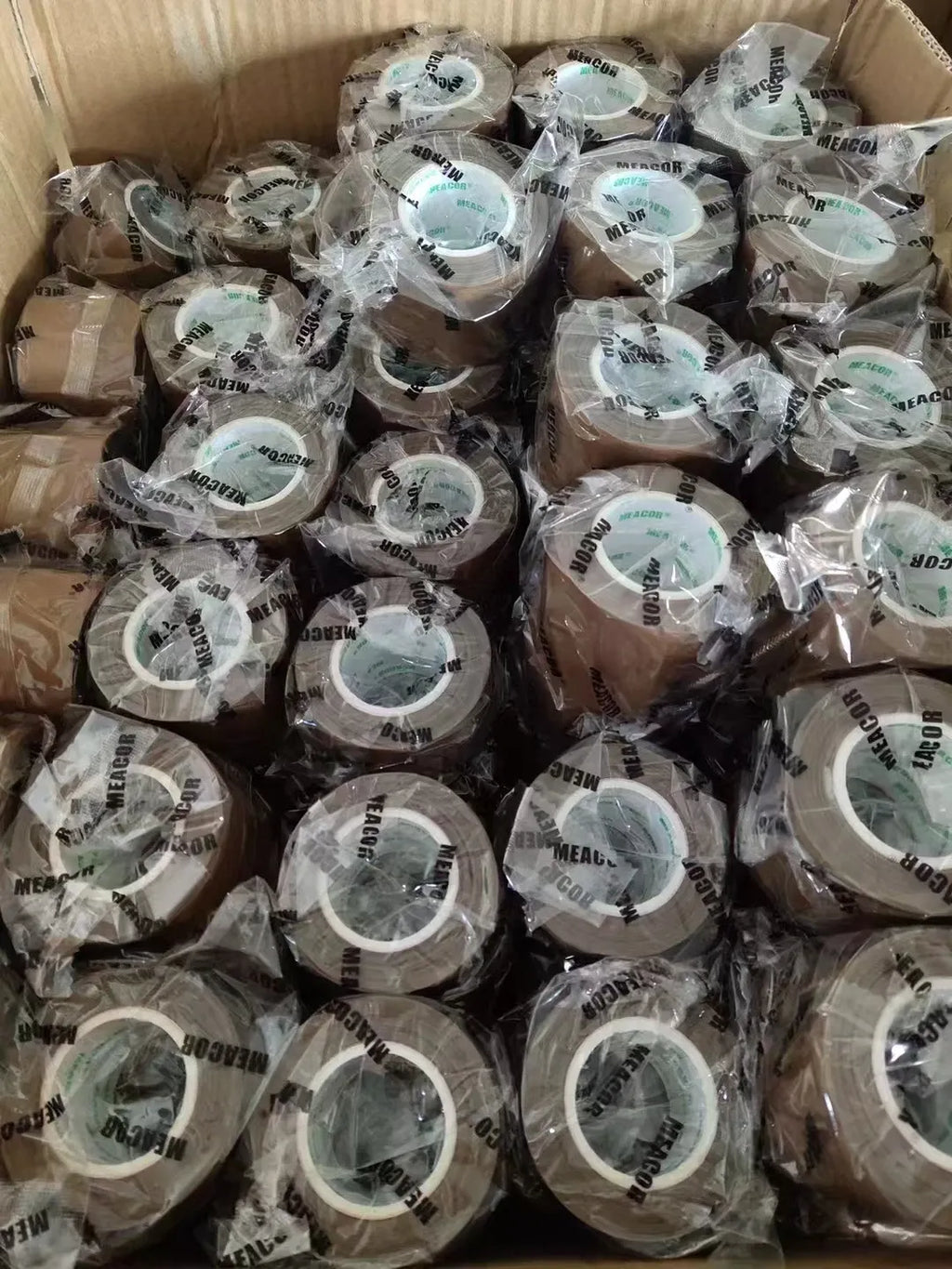 Packed heat-sealing tape rolls in clear wrap inside a shipping carton